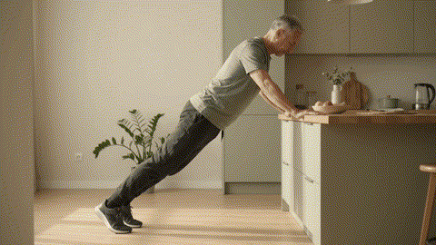 Incline push-up for beginners Fitness category avatar demonstrating a controlled incline push-up on a sturdy counter.